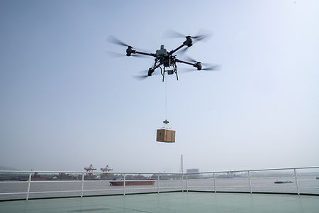 DJI FlyCart 30 flying over Saudi landscape performing aerial delivery
